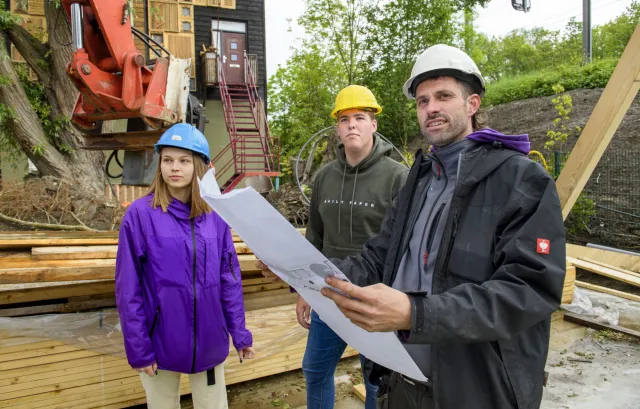 Technisch leidinggevende in de bouw geeft aanwijzingen aan collega’s.