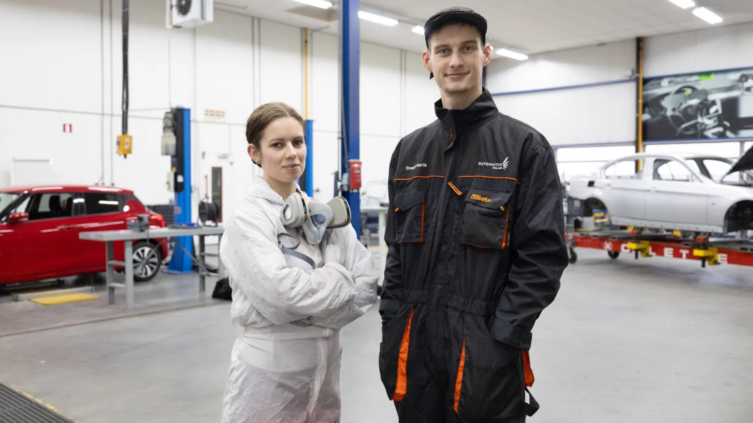 Studenten schadeherstel Autospuiten poseren in werkplaats